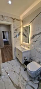 a bathroom with a sink and a toilet in it at Arkle Apartment 1 in Tirana