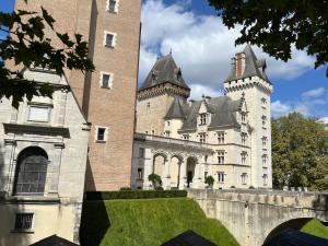 a castle with two towers on top of a building at Studio Le Balcon du Béarn in Livron