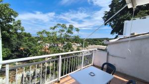a balcony with a table and a view of the street at Pansion Galini in Therma