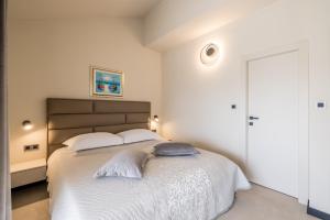 a bedroom with a large bed with white sheets at Guesthouse Rooms Split in Split