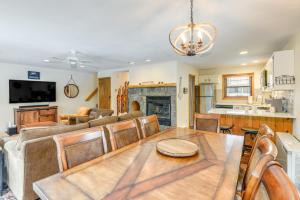 a dining room and living room with a table and a couch at 3 min to Mt Snow with FREE Shuttle! Family-Size fun, Wood fireplace, 2 living rooms, Arcades in Dover