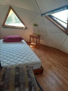 a room with a bed and a table in a tent at CABAÑA DOMO EN VILLARICA TERRADOMOS AFUNALHUe in Nalcahue