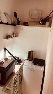 a small kitchen with a refrigerator and a microwave at Sibejdo 3&4 in Varaždin