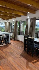 a dining room with a table and chairs on a wooden floor at La Casa de Bianca in El Soberbio +21 photos