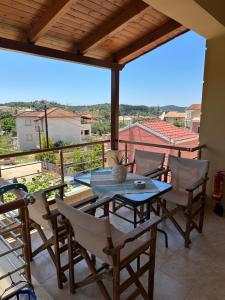 a patio with a table and chairs on a balcony at Dreamcatcher Sivota in Syvota