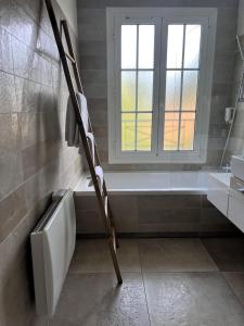 a bathroom with a bath tub and a window at Hôtel Beau Site - Cap d'Antibes in Antibes
