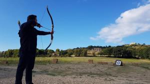 a man holding a bow and arrow in a field at La Terrazza di Laurino in Laurino +36 photos