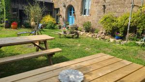 a picnic table in a yard with a flower on it at Nuit insolite tente Grandi'Ose proche Mont Saint Michel in Le Ferré