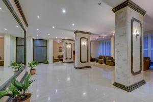 a lobby with pillars and furniture in a building at Hotel Shipka All Inclusive in Golden Sands +285 photos