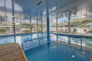 a large swimming pool in a building at Hotel Shipka All Inclusive in Golden Sands
