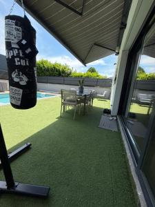 a patio with a table and chairs and a pool at Le soleil de pessac in Pessac