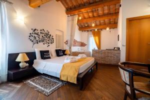 a bedroom with a large bed in a room at Resort Tenuta La Rotta - Rooms & Pool in Ravenna +63 photos