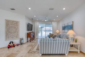 a living room with a couch and a table at Life's Porpoises - 29 Coconut Ct in Palm Coast