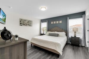 a bedroom with a large bed and a large window at Remarkable Cozy 4Bed-3Ba Townhouse in Kissimmee +28 photos