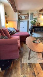 a living room with a couch and a table at Duplex, jacuzzi, terrasse sur les toits in Nice +5 photos
