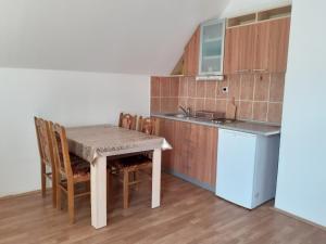 a kitchen with a table and chairs in a room at Apartman Ruza in Soko Banja