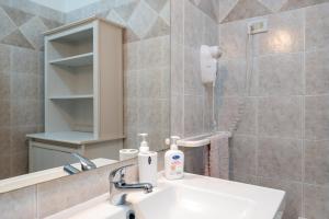 a bathroom with a sink and a mirror at Frontemare in Porto Cesareo