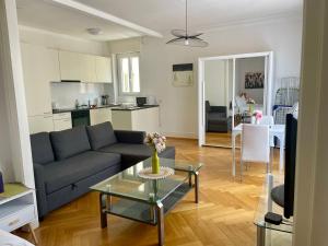 a living room with a couch and a table at 6 minutes walking from Lausanne railway station in Lausanne