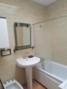 a bathroom with a sink and a toilet and a tub at La Pointe de Sel - Plage a 2 minutes a pied in Lumio +12 photos
