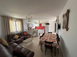 a living room with a table and a couch at DAR AZAIEZ El Haouaria Villa 4 Chambres climatisé belle piscine in El Haouaria