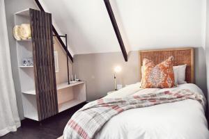 a bedroom with a bed with a wooden headboard at Palm Villa Beachfront Accomodation in Hentiesbaai