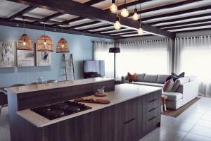a kitchen with a counter with a stove in it at Palm Villa Beachfront Accomodation in Hentiesbaai