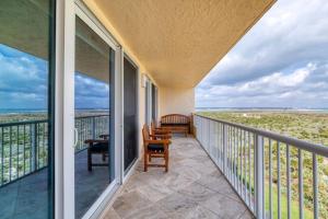 a balcony with a view of the ocean at New Smyrna Beachfront Modern 9th Floor Condo Pool Hot Tub in New Smyrna Beach