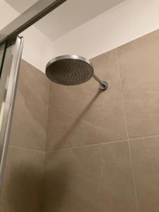 a shower with a shower head in a bathroom at Casa Primavera in Cinquale