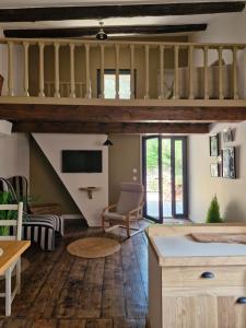 a living room with a staircase and a table and chairs at Cyprès du château in Le Barroux