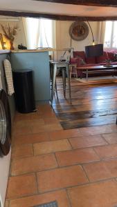 a living room with a table and a couch at Duplex, jacuzzi, terrasse sur les toits in Nice