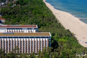 a hotel on a hill next to a beach at Prestige Pinea 713 - Easy - Rent Apartments in Pobierowo