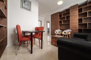 a living room with a table and chairs and a couch at No8 Spacious City Center Apartment in Bratislava