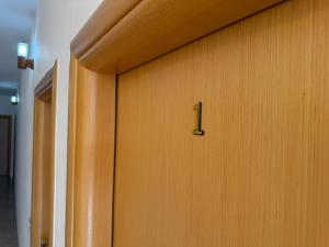 a wooden door with the number one on it at Anmaor in Qeparo