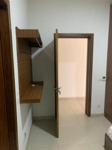 a hallway with an open door to a stair case at Sloane House in Dawhwenya