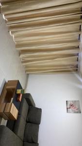 a living room with a couch and a table at Sloane House in Dawhwenya +1 photo