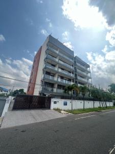 a tall building with a fence in front of it at Sloane House in Dawhwenya