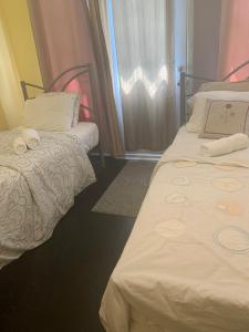 a room with two beds and a window at Montreal Downtown Private Room in Montreal