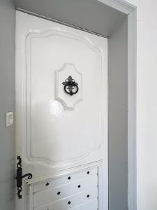 a white door in a room with a drawer at Appartement de charme Erdizka classé 3 étoiles in Bayonne +7 photos