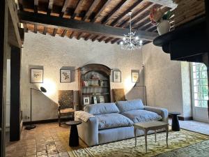 a living room with a blue couch and a table at Domaine du Cèdre Eternel in Saint-Colomb-de-Lauzun +25 photos