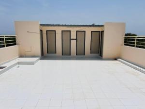 a large empty room with doors on a building at Vasavi Palace Residency in Pennāttūr
