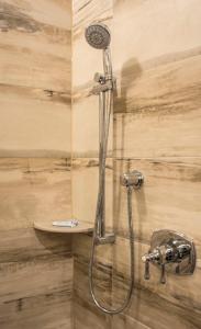 a shower with a shower head in a bathroom at The Delavan Hotel in Buffalo