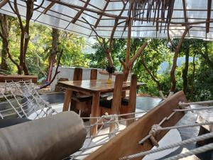 a table and chairs on a patio with an umbrella at Ella Retreat Hotel Villa for Nature Lovers in Ella