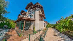 a house with a fence around it at Jungle Family Villa near Park Aventura,Lake,Zoo in Braşov