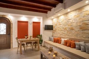 a living room with a couch and a table at Tsolias Stone House 2 in Palekastron
