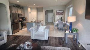 a kitchen and living room with two chairs and a table at Gayson Gardens Drive Richmond Texas USA in Richmond