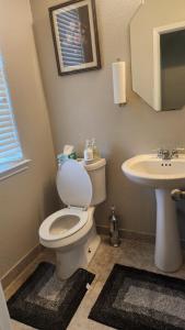 a bathroom with a toilet and a sink at Gayson Gardens Drive Richmond Texas USA in Richmond