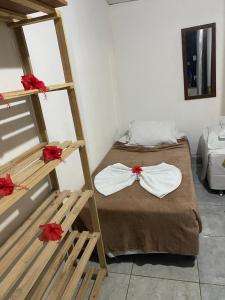 a room with two bunk beds with red bows at Casa da Silvana in Fernando de Noronha