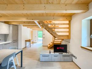 an open kitchen and dining room with wooden ceilings at Luxury Chalet Dolomiti-Campiglio-Trentino in Porte di Rendena