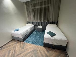 two beds in a small room with at Najla Sh4 in Tangier