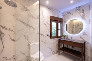 a bathroom with a shower with a sink and a mirror at Villa MORERA in Vilaseca de Solcina